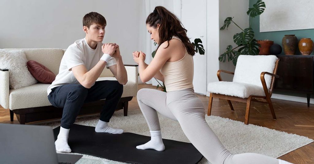 Personal trainer conducting a one-on-one in-home workout session in a Chapel Hill living room.